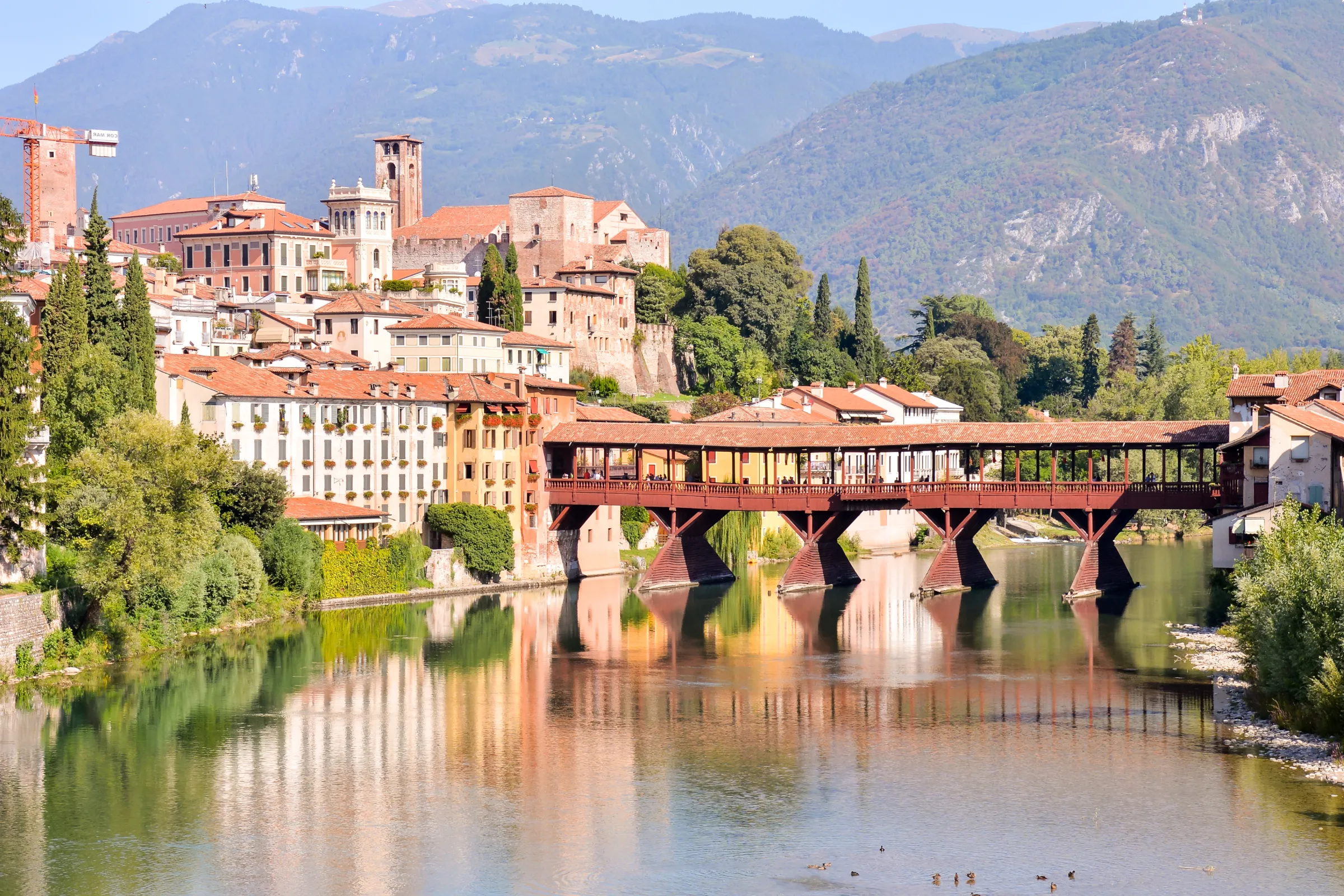 Ponte degli Alpini and the old town of Bassano del Grappa beneath the mountains