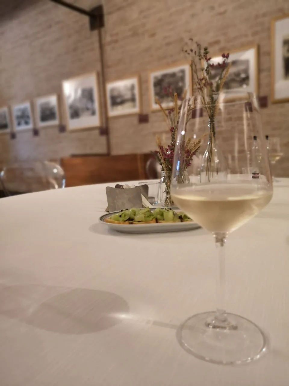 Glass of local white wine and cicchetti served on a restaurant table