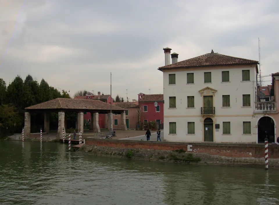 Old boat shelter and Venetian houses along the Brenta canal