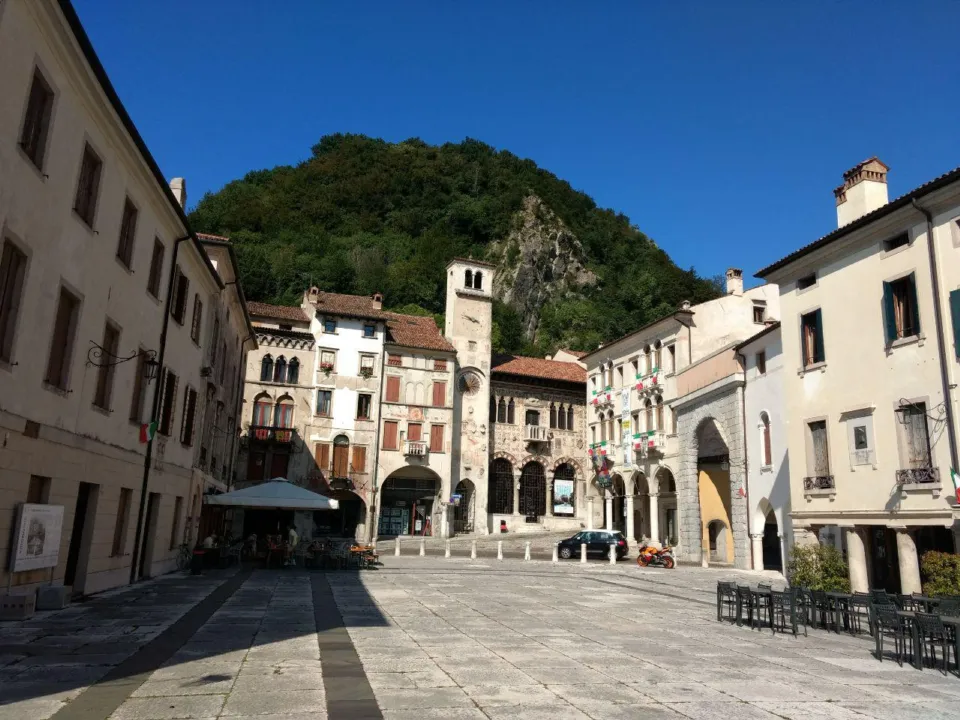 Arcaded Piazza Flaminio in Serravalle, Vittorio Veneto, at the foot of wooded hills