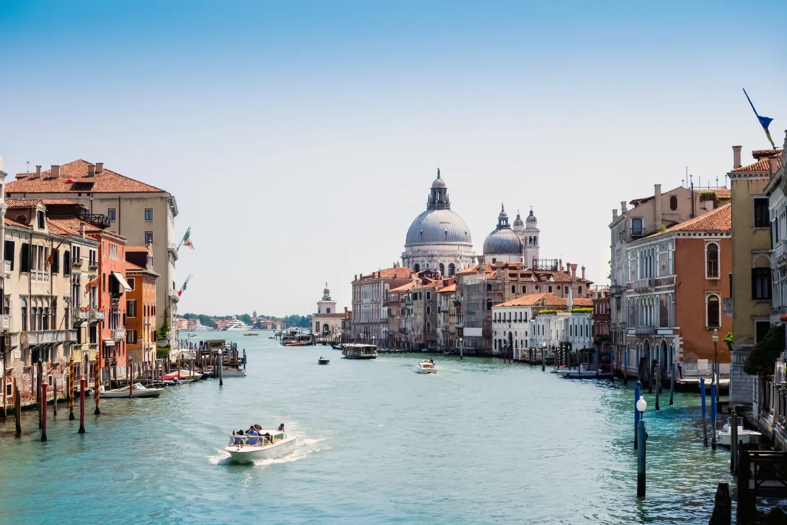 Grand Canal in Venice with the domes of Santa Maria della Salute and passing water taxis