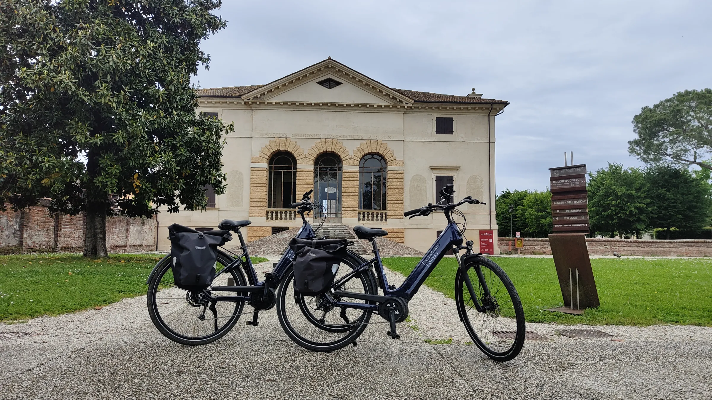 E-bikes with panniers parked in front of Palladio's Villa Caldogno near Vicenza